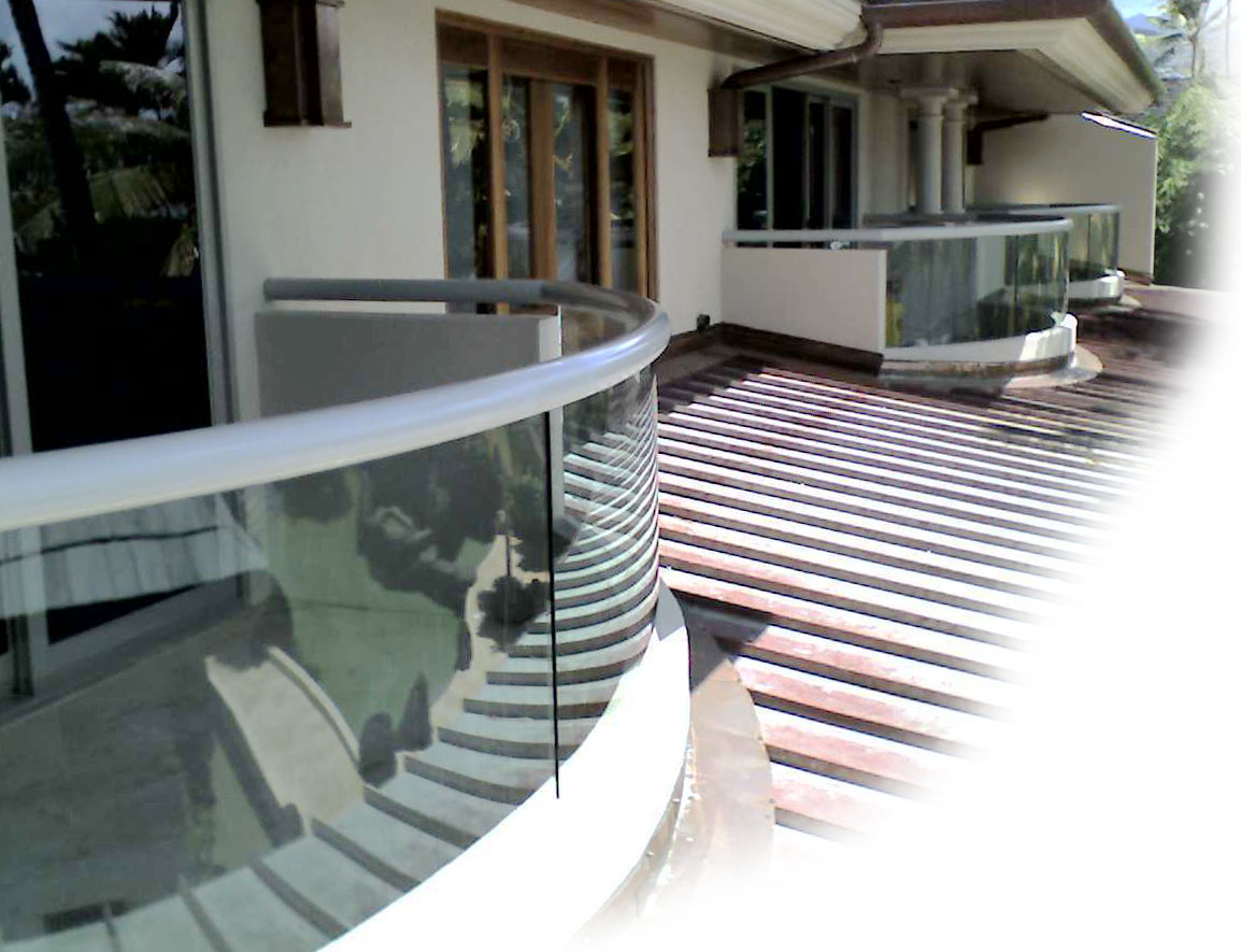 photo: custom curved glass balcony railings for unobstructed views from an elegant residence.